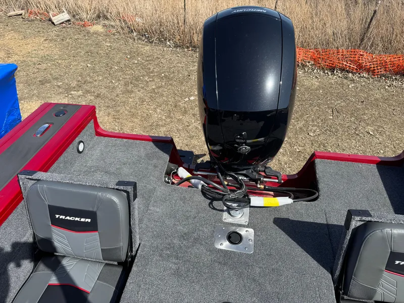 Slide: The Image of 2025 Tracker Targa V-18 Combo boat interior with motor and seating. - 15