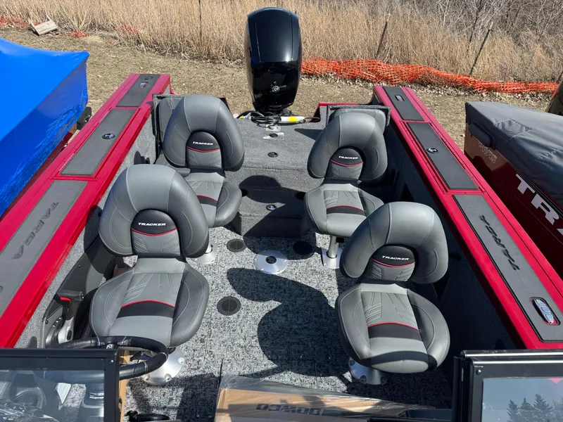 Slide: The Image of 2025 Tracker Targa V-18 Combo boat interior with six gray seats and red accents. - 18