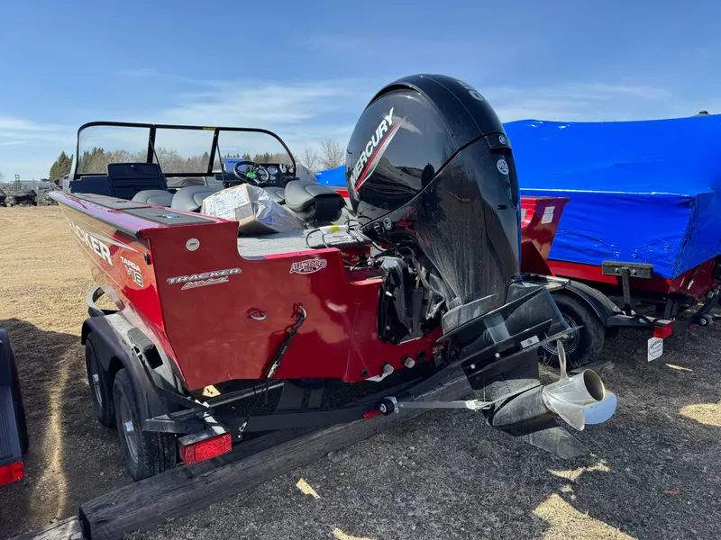 Slide: The Image of 2025 Tracker Targa V-18 Combo boat with Mercury outboard motor, parked on a trailer. - 3