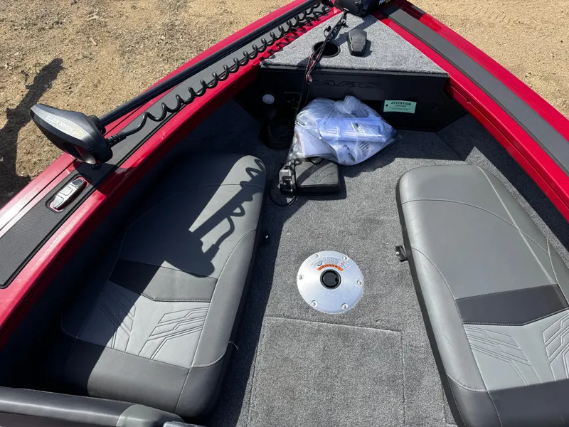 Slide: The Image of 2025 Tracker Targa V-18 Combo boat interior with gray seating and red trim. - 6