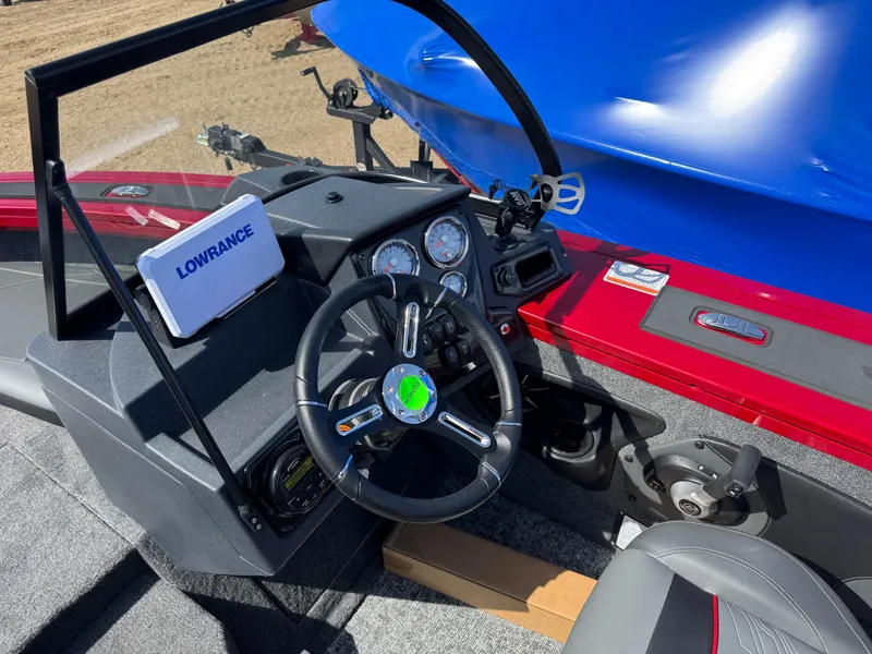 Slide: The Image of 2025 Tracker Targa V-18 Combo boat dashboard with Lowrance system and steering wheel. - 8