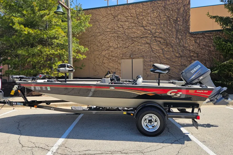 Slide: The Image of 2010 G3 180 boat with Yamaha motor on trailer in parking lot. - 0