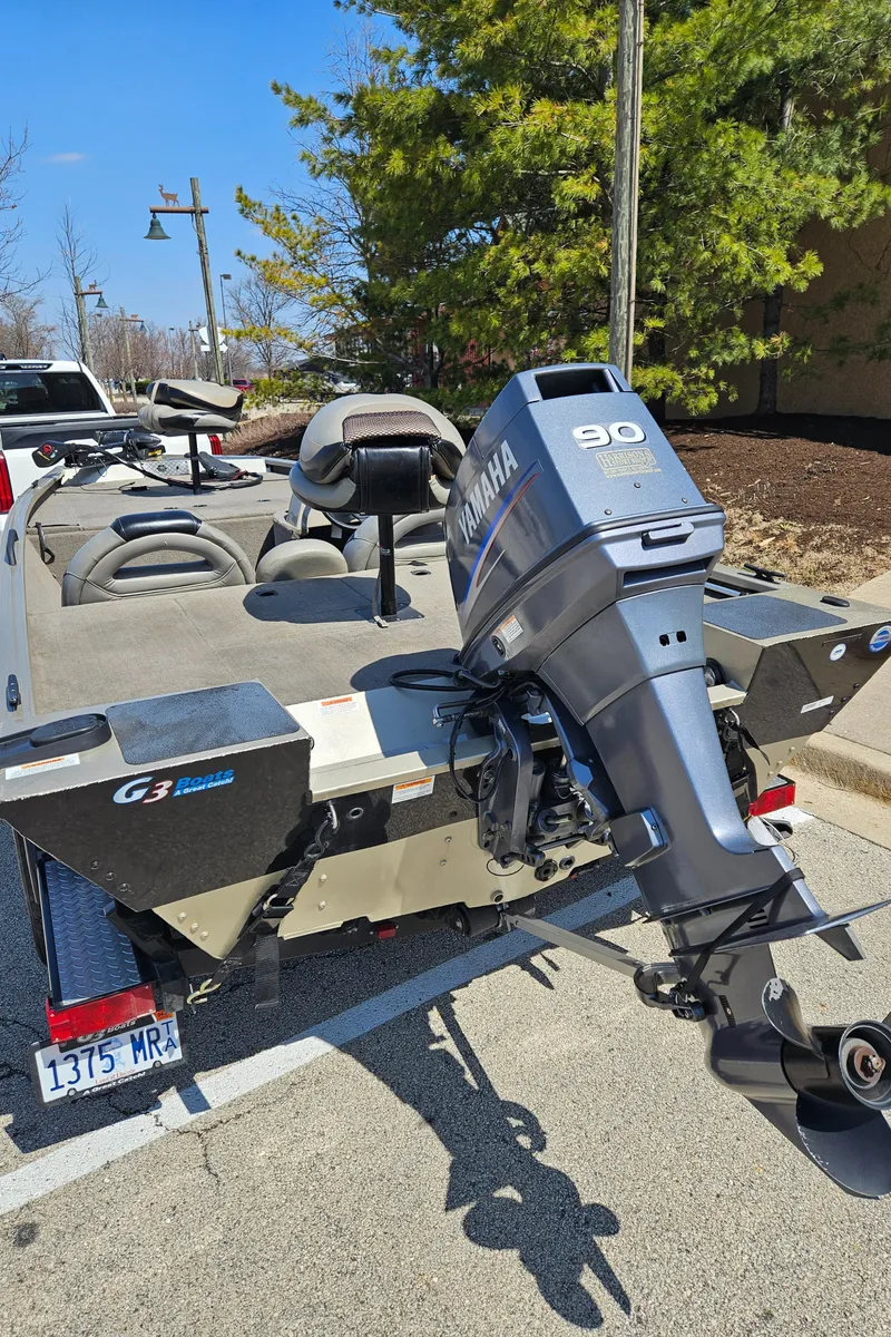 Slide: The Image of 2010 G3 180 boat with Yamaha 90 outboard motor on a trailer. - 2