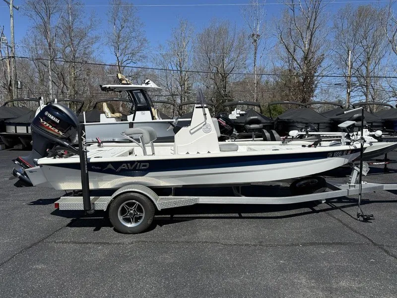 Slide: The Image of 2022 Avid 19 FS boat on trailer, parked outdoors, side view. - 1