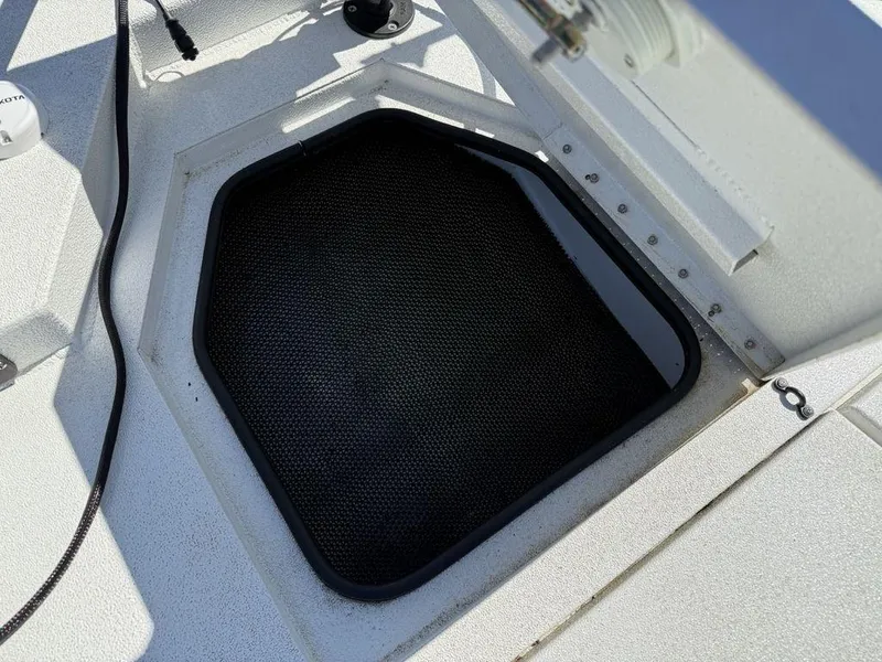 Slide: The Image of Open storage compartment on 2022 Avid 19 FS boat deck. - 10
