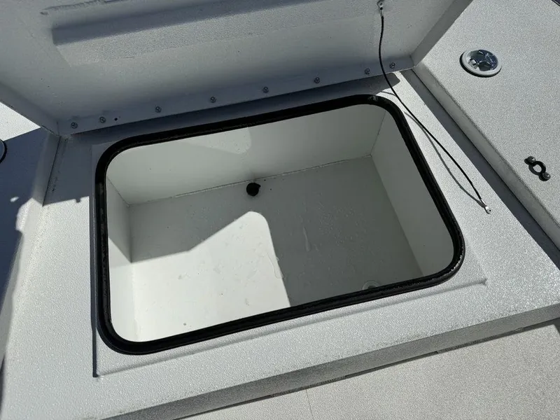 Slide: The Image of Open storage compartment on 2022 Avid 19 FS boat deck. - 12