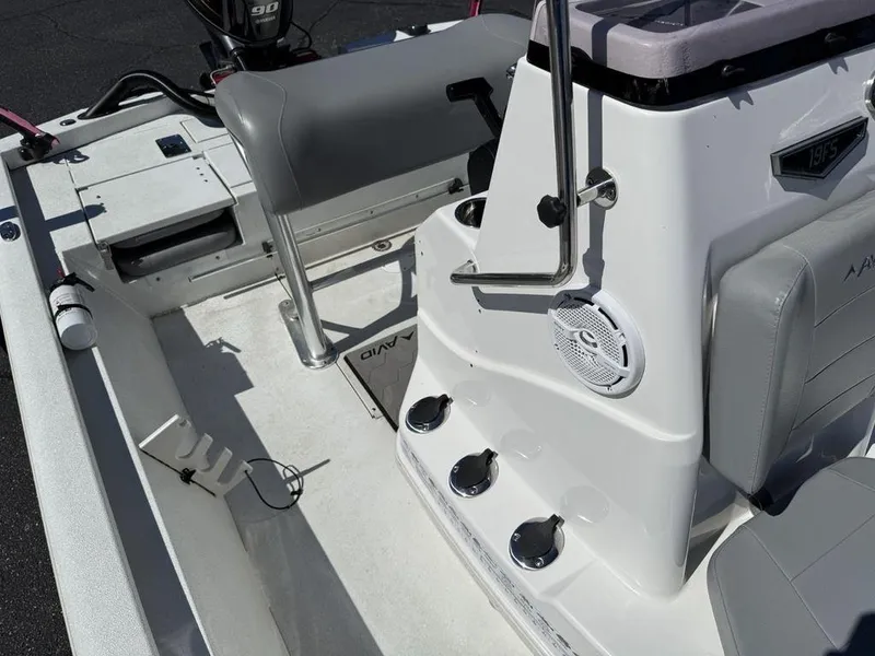 Slide: The Image of 2022 Avid 19 FS boat interior with seating, console, and controls. - 15