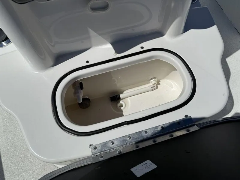Slide: The Image of Livewell compartment on a 2022 Avid 19 FS boat, featuring a clean, white interior. - 16
