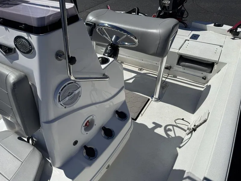Slide: The Image of 2022 Avid 19 FS boat interior with seating and control panel. - 17