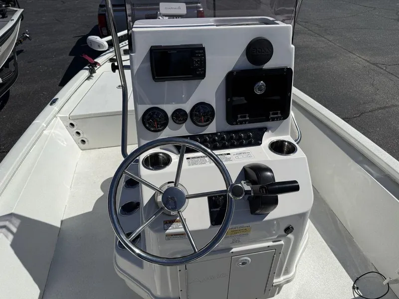 Slide: The Image of 2022 Avid 19 FS boat console with steering wheel and navigation controls. - 19