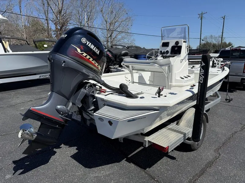 Slide: The Image of 2022 Avid 19 FS boat with Yamaha outboard motor, parked on a trailer. - 2