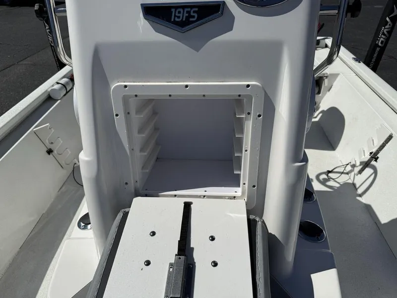 Slide: The Image of 2022 Avid 19 FS boat console with open storage compartment. - 22
