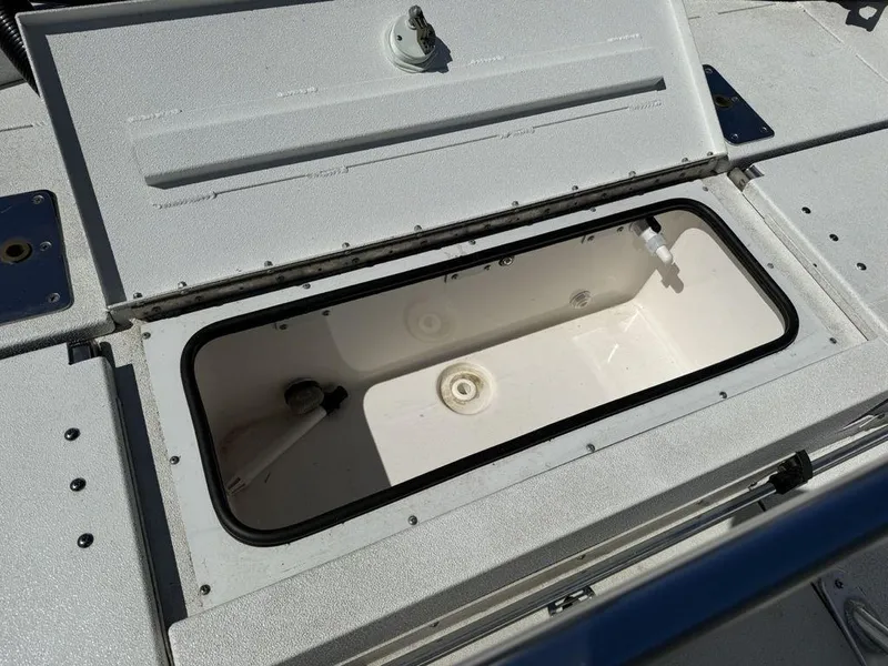 Slide: The Image of Open storage compartment on 2022 Avid 19 FS boat deck. - 25