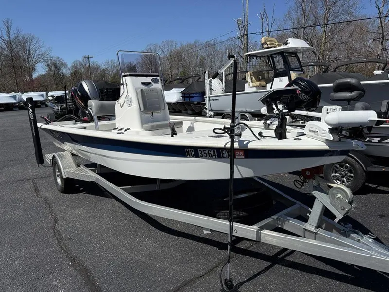 Slide: The Image of 2022 Avid 19 FS boat on trailer, parked outdoors, with motor and equipment. - 3