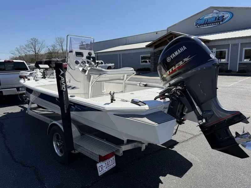 Slide: The Image of 2022 Avid 19 FS boat with Yamaha outboard motor, parked outside a dealership. - 6