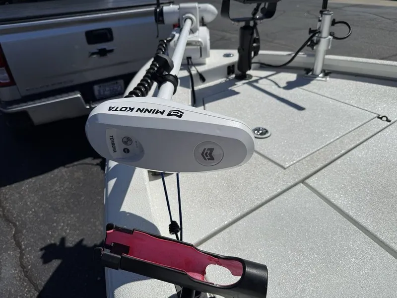 Slide: The Image of Avid 19 FS boat with Minn Kota trolling motor, 2022 model, parked near a truck. - 9