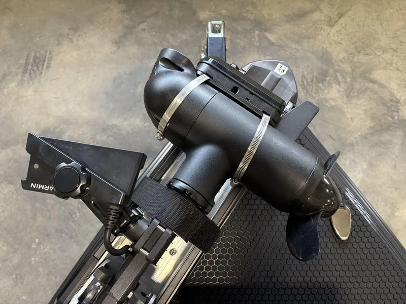 Slide: The Image of A 2025 Phoenix 721 ZXL boat motor with Garmin equipment on a textured surface. - 11