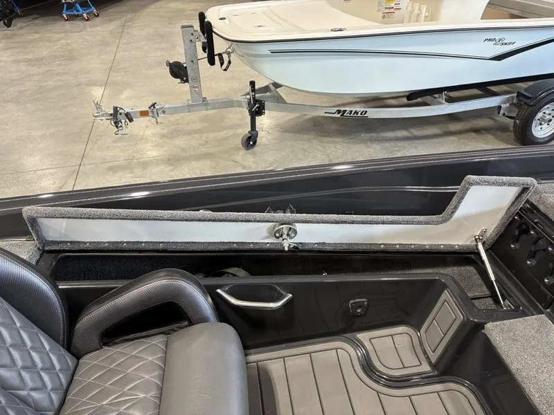 Slide: The Image of Interior of a 2025 Phoenix 721 ZXL boat with open storage compartment. - 17