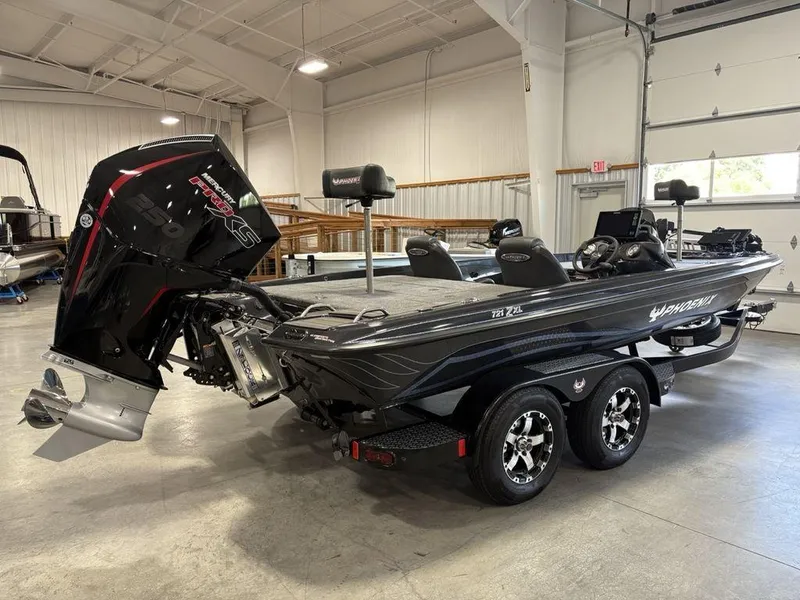 Slide: The Image of 2025 Phoenix 721 ZXL boat with Mercury Pro XS engine in a showroom. - 2