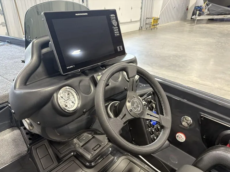 Slide: The Image of 2025 Phoenix 721 ZXL boat dashboard with steering wheel and navigation display. - 27