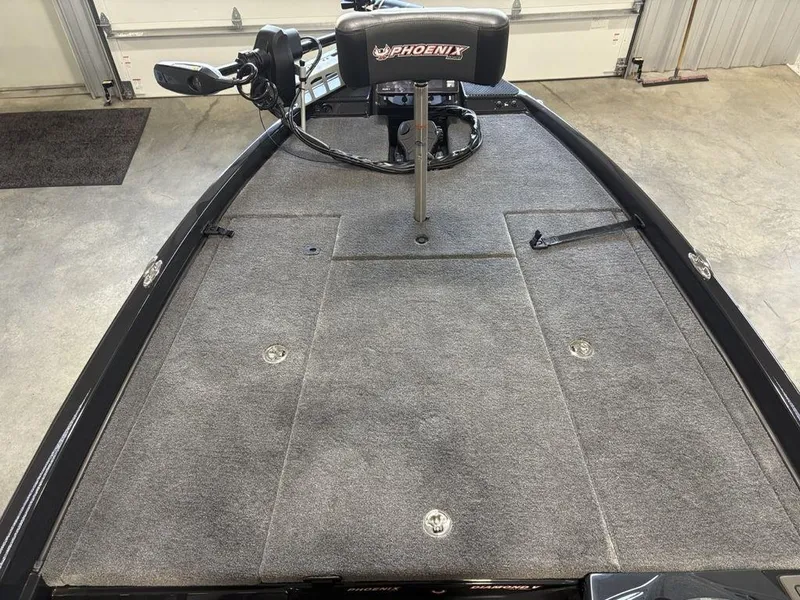 Slide: The Image of 2025 Phoenix 721 ZXL boat deck with gray carpet and Phoenix-branded seat. - 7