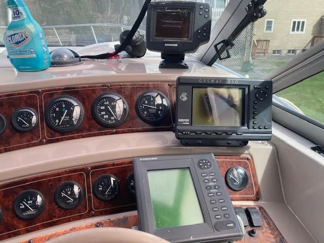 Slide: The Image of 1997 Chaparral 31 boat dashboard with navigation instruments and cleaning product. - 12