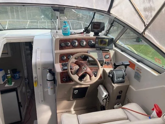 Slide: The Image of Interior view of a 1997 Chaparral 31 boat cockpit with steering wheel and navigation instruments. - 13