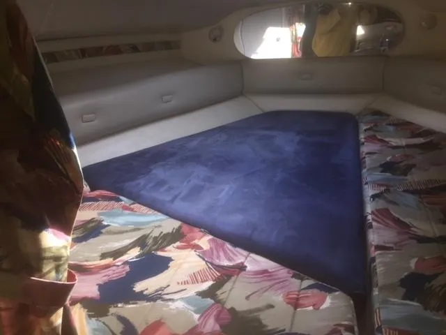 Slide: The Image of Interior cabin of a 1997 Chaparral 31 boat with colorful upholstery. - 4