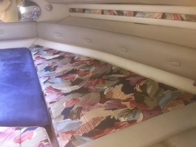 Slide: The Image of 1997 Chaparral 31 interior with colorful patterned upholstery and beige walls. - 5
