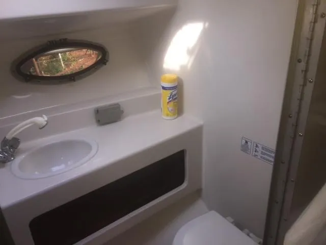 Slide: The Image of Interior of 1997 Chaparral 31 boat bathroom with sink and cleaning wipes. - 9