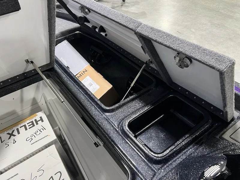 Slide: The Image of Open storage compartments in a 2025 Phoenix 920 Elite boat, showcasing organized interior space. - 10