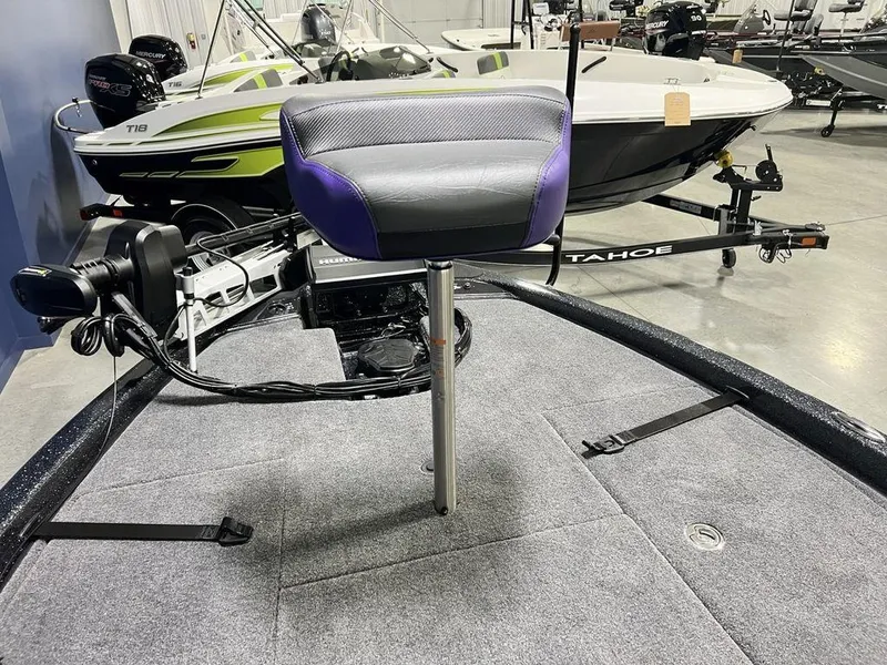 Slide: The Image of 2025 Phoenix 920 Elite boat interior with a swivel seat and trolling motor. - 11