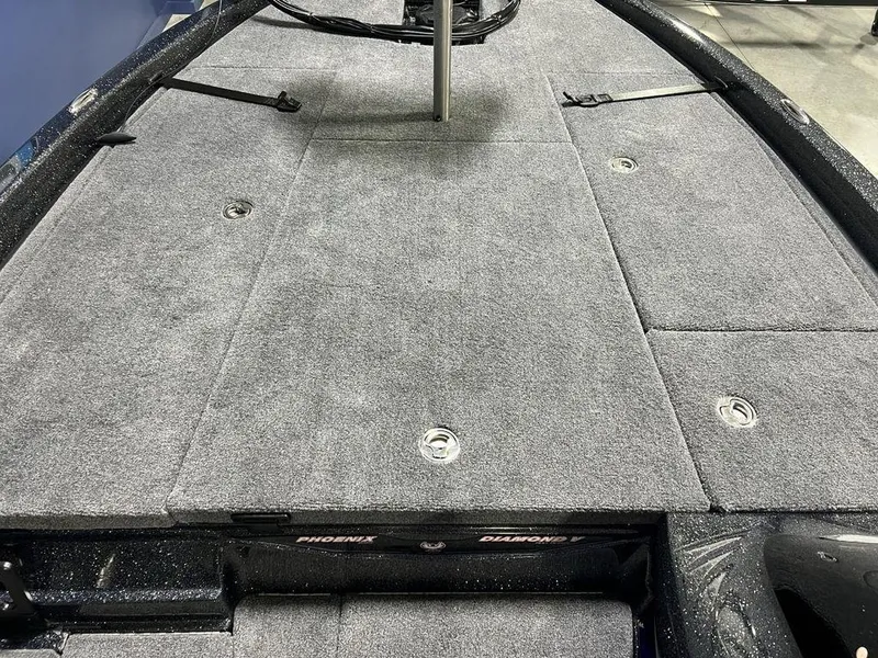 Slide: The Image of 2025 Phoenix 920 Elite boat deck with gray carpet and storage compartments. - 12