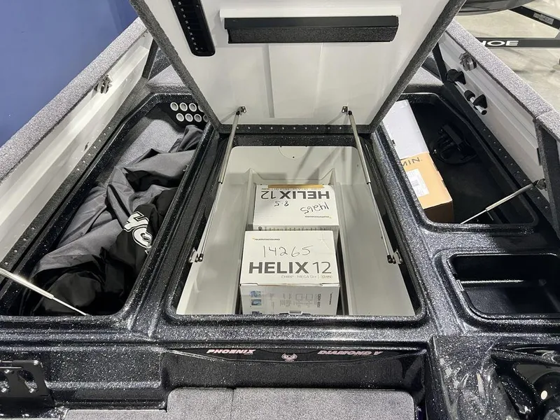 Slide: The Image of Open storage compartment in 2025 Phoenix 920 Elite boat with Helix 12 boxes inside. - 16