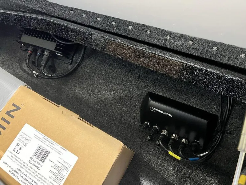 Slide: The Image of Interior electronics of 2025 Phoenix 920 Elite boat with Humminbird system and packaging box. - 17