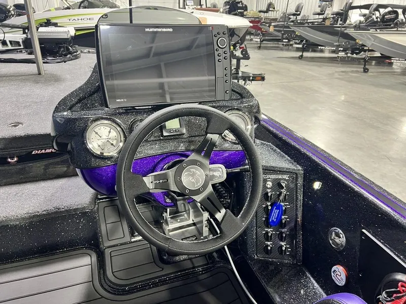 Slide: The Image of Cockpit of 2025 Phoenix 920 Elite boat with steering wheel and navigation display. - 18
