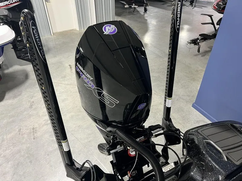 Slide: The Image of 2025 Phoenix 920 Elite boat engine with Power-Pole anchors in a showroom. - 20