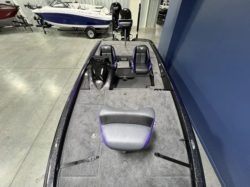 Slide: The Image of 2025 Phoenix 920 Elite boat interior with gray and purple seating, in showroom. - 27