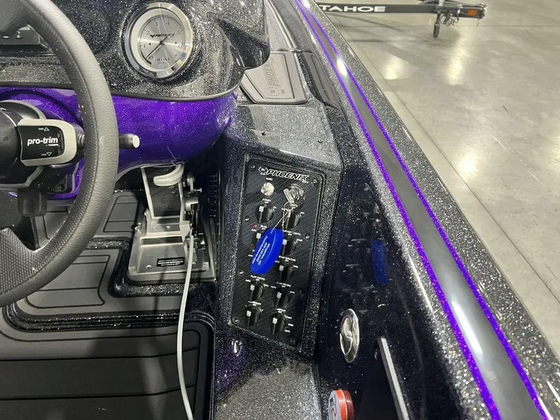 Slide: The Image of Dashboard of a 2025 Phoenix 920 Elite boat with control panel and steering wheel. - 28