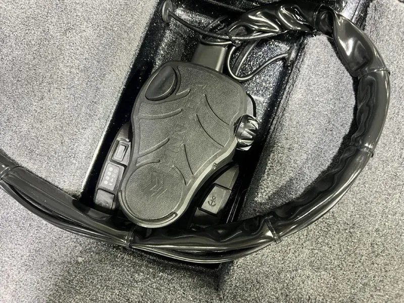 Slide: The Image of Foot pedal control in a 2025 Phoenix 920 Elite boat, featuring sleek design and wiring. - 3