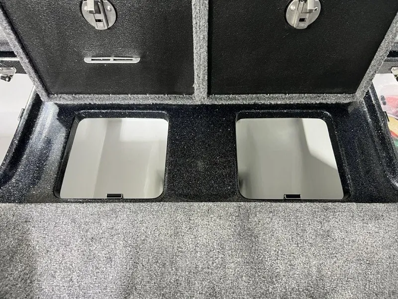 Slide: The Image of 2025 Phoenix 920 Elite storage compartments with secure latches and carpeted interior. - 31