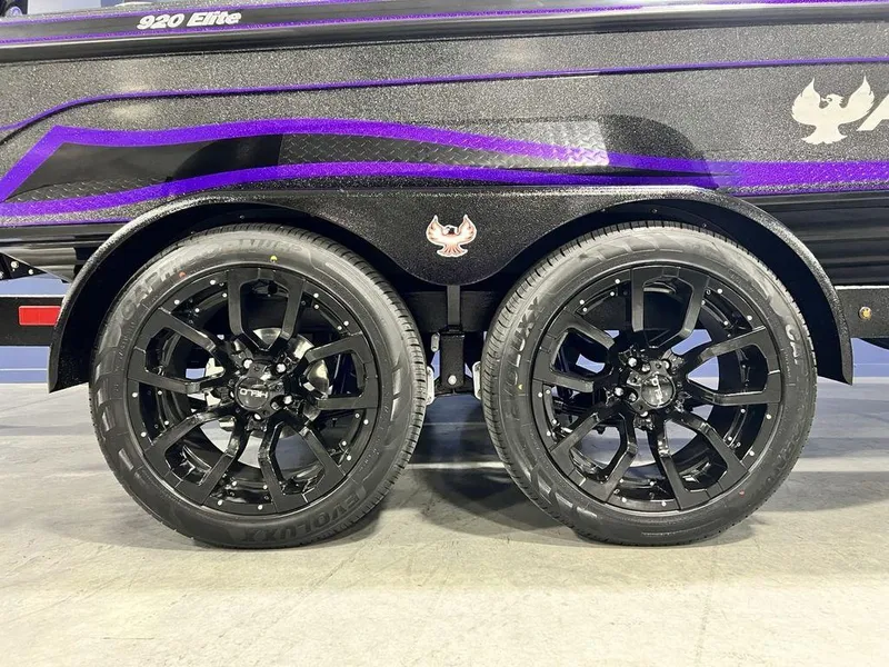 Slide: The Image of 2025 Phoenix 920 Elite trailer with sleek black wheels and purple accents. - 4