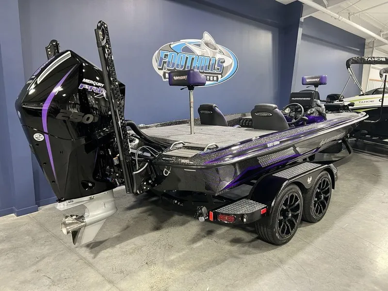 Slide: The Image of 2025 Phoenix 920 Elite boat with Mercury engine, displayed indoors at dealership. - 5