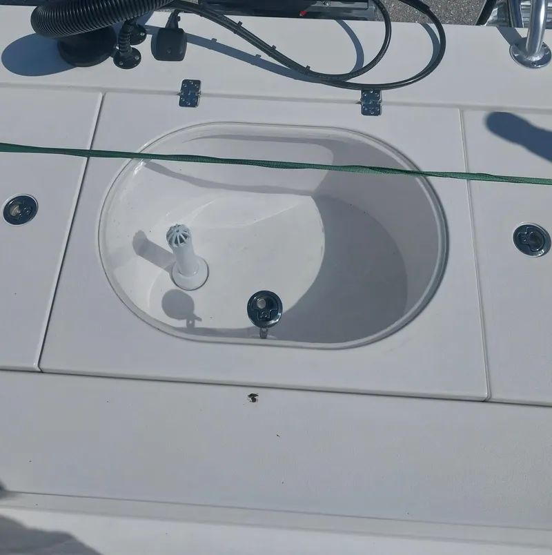 Slide: The Image of 2024 Savage Seas Shallow Bay SS22 boat deck with built-in sink and fixtures. - 16