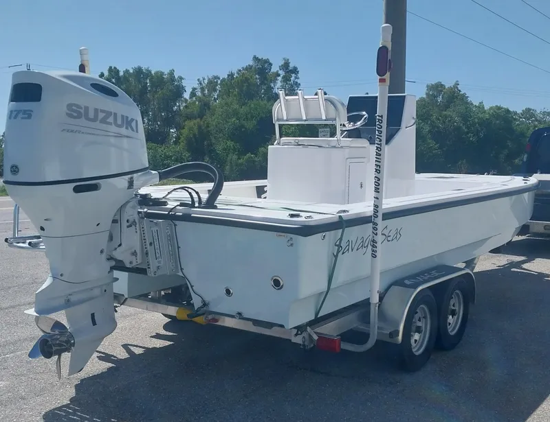 Slide: The Image of 2024 Savage Seas Shallow Bay SS22 boat on trailer with Suzuki outboard motor. - 3