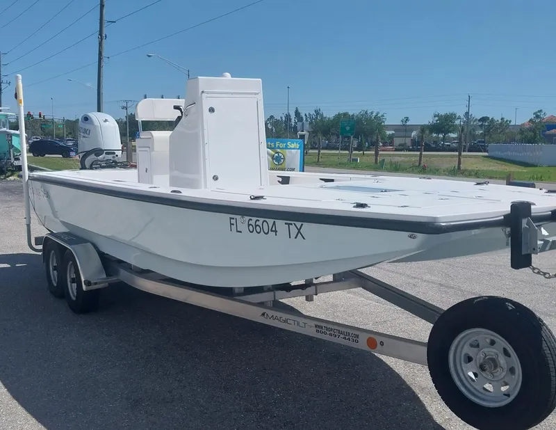 Slide: The Image of 2024 Savage Seas Shallow Bay SS22 boat on trailer, parked outdoors. - 4