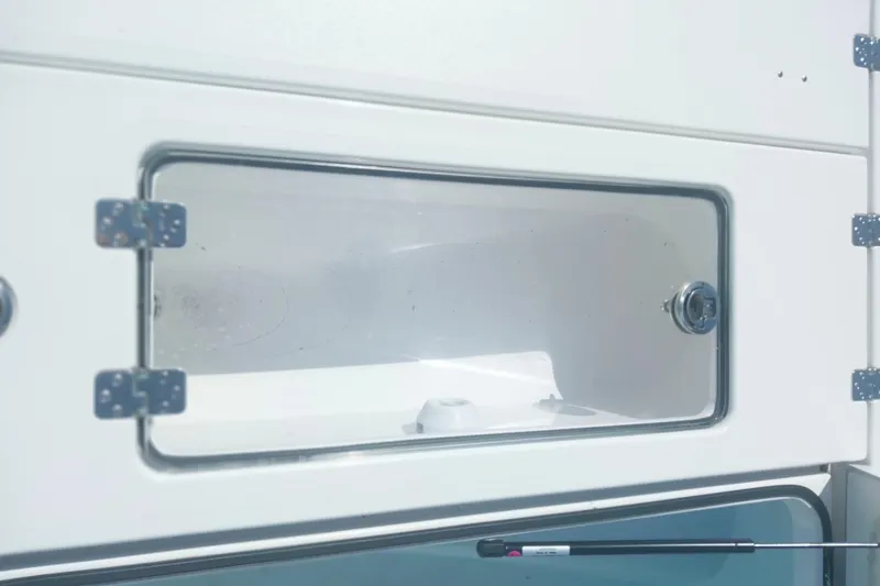 Slide: The Image of Storage compartment of 2024 Savage Seas Shallow Bay SS22 boat, featuring secure latch and sleek design. - 8