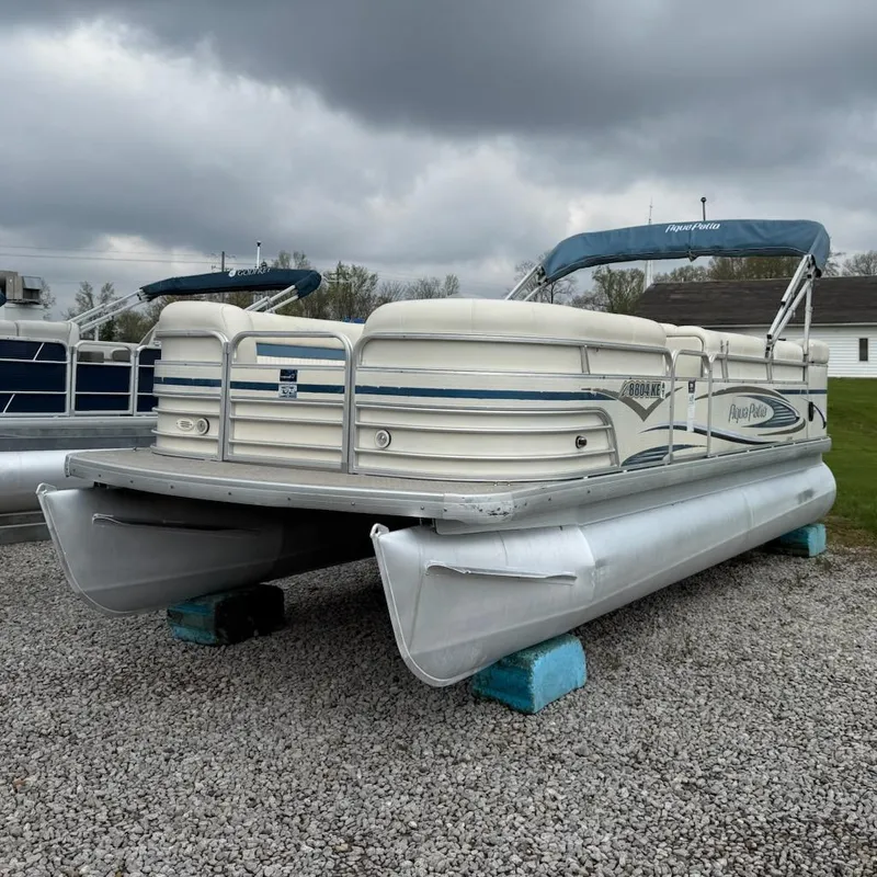 Slide: The Image of 2007 Godfrey Aqua Patio 200 RE 3 pontoon boat on gravel, under cloudy sky. - 3