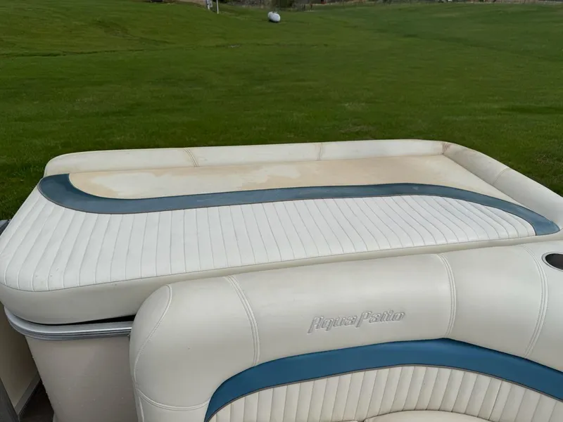 Slide: The Image of 2007 Godfrey Aqua Patio 200 RE 3 boat seating with white and blue upholstery. - 7