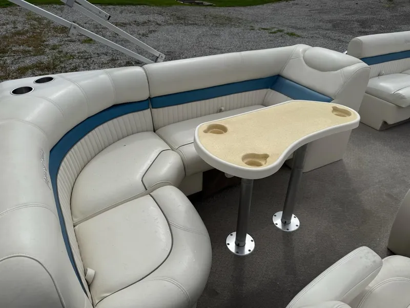Slide: The Image of 2007 Godfrey Aqua Patio 200 RE 3 boat interior with white seating and table. - 8